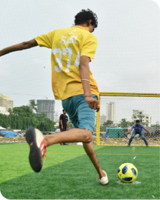 SI player taking a football kick on turf